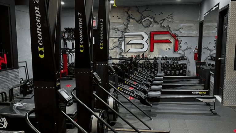 Brooklyn fitness entrepreneur Anthony Espo coaching members at Bad Ass Academy gym, promoting strength training, mindset development, and supportive fitness community leadership.