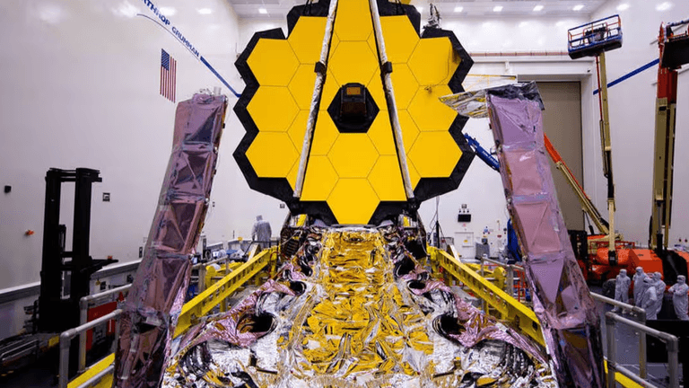 The James Webb Space Telescope in a clean room, showcasing its golden hexagonal mirrors