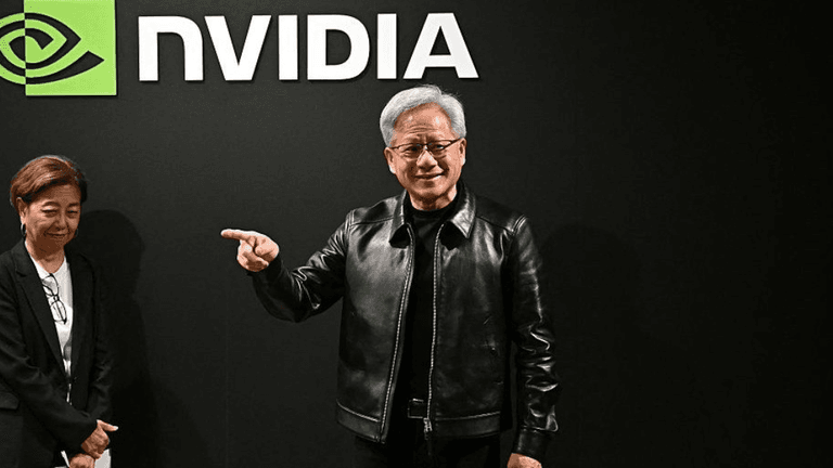 A man in a leather jacket gestures confidently beside a woman in a blazer, with NVIDIA logo.