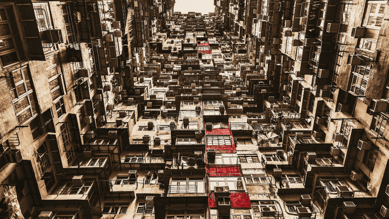 Dense apartment buildings viewed upward, repeating balconies and windows forming abstract inner-city pattern with warm tones.