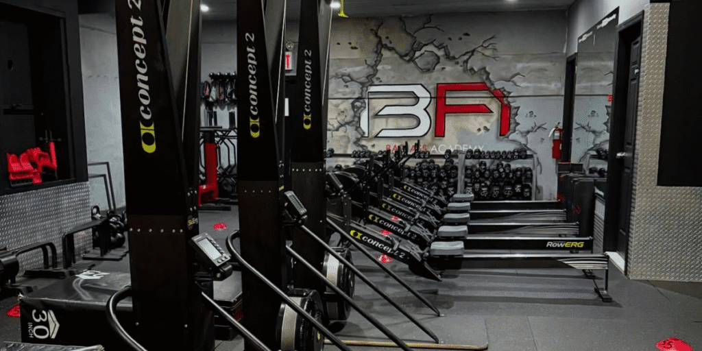 Brooklyn fitness entrepreneur Anthony Espo coaching members at Bad Ass Academy gym, promoting strength training, mindset development, and supportive fitness community leadership.